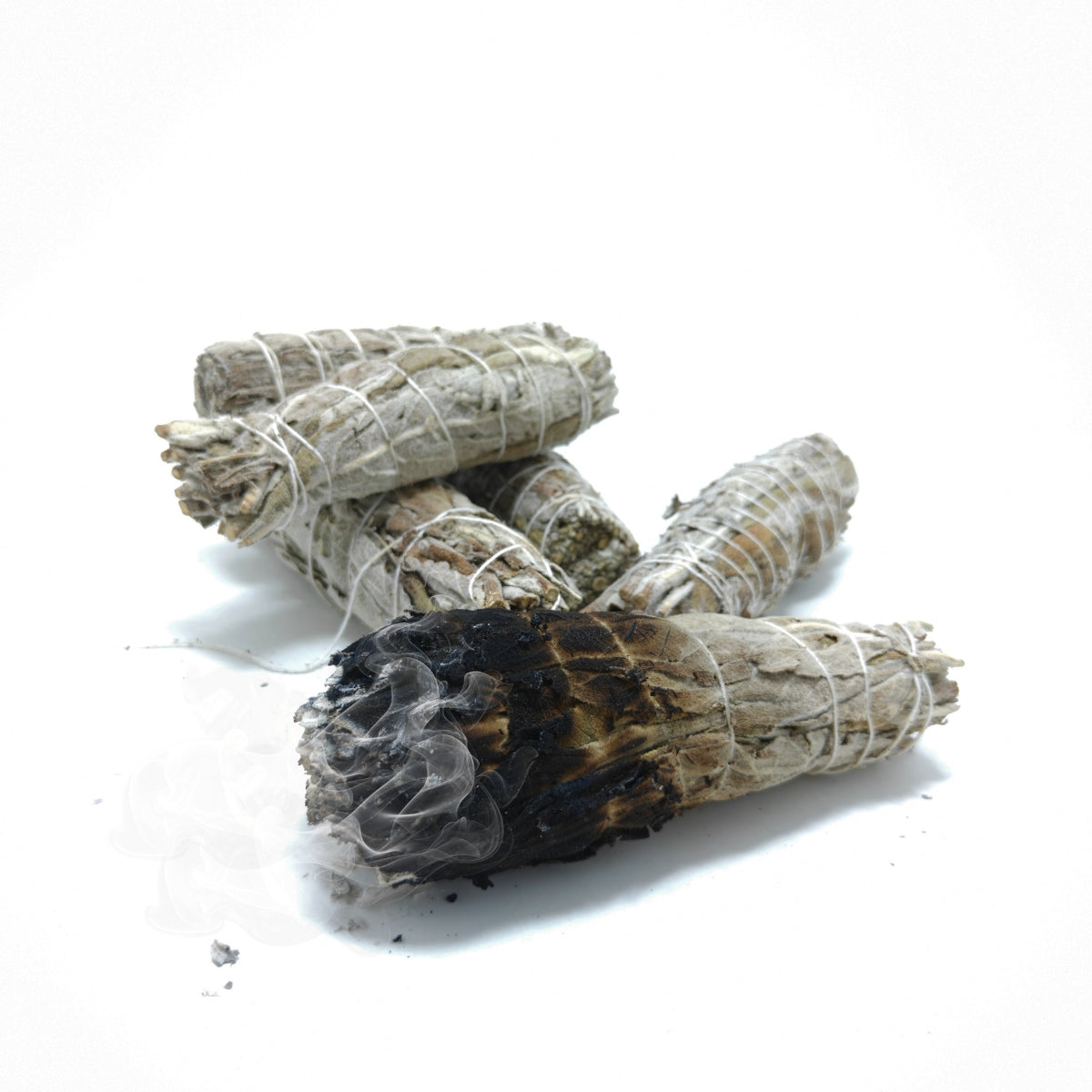 Burning white sage smudge stick with smoke, used for cleansing and smudging rituals