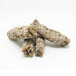 Bundle of dried white sage smudge sticks showing herb texture and cotton wrap