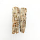 Two natural white sage smudge sticks tied with cotton string on white background